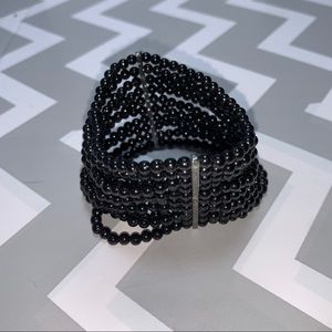 Small bead wide multi strand bracelet